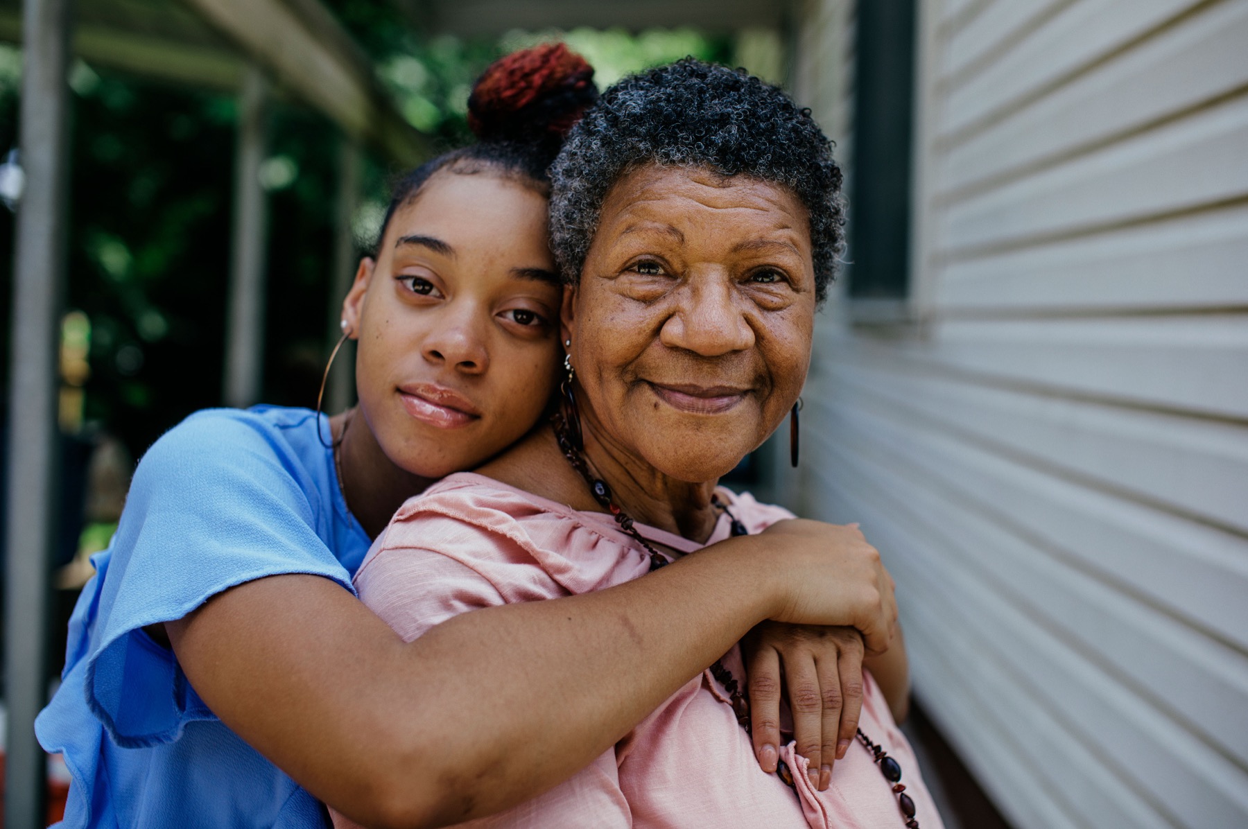 An older woman and a younger woman sharing a warm embrace